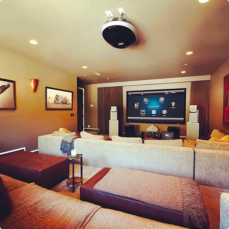 Living room home theater with ceiling projector and speakers