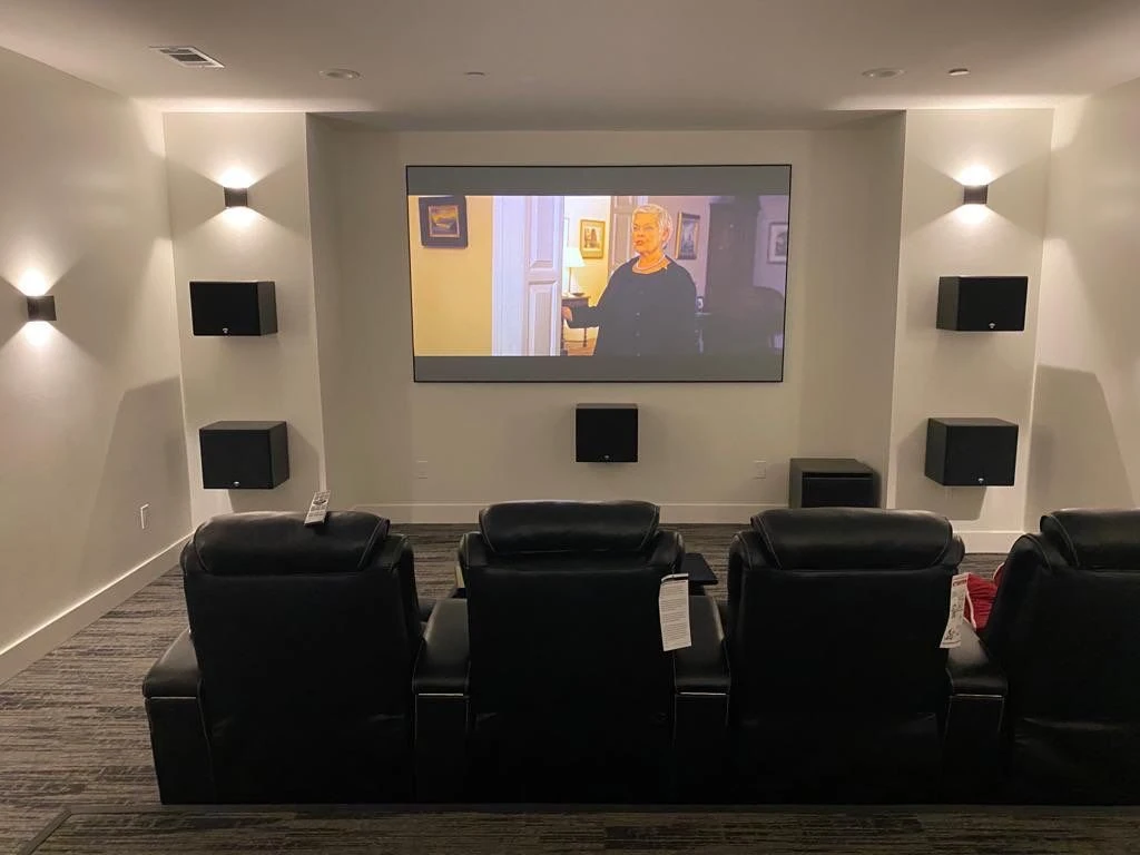 Dedicated home theater with recliners and surround speakers